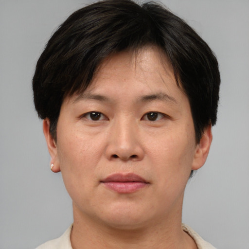 Joyful asian adult female with short  brown hair and brown eyes