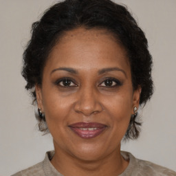 Joyful black adult female with short  brown hair and brown eyes