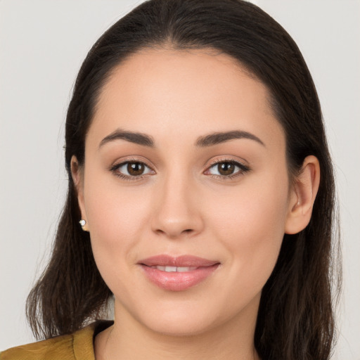 Joyful white young-adult female with long  brown hair and brown eyes