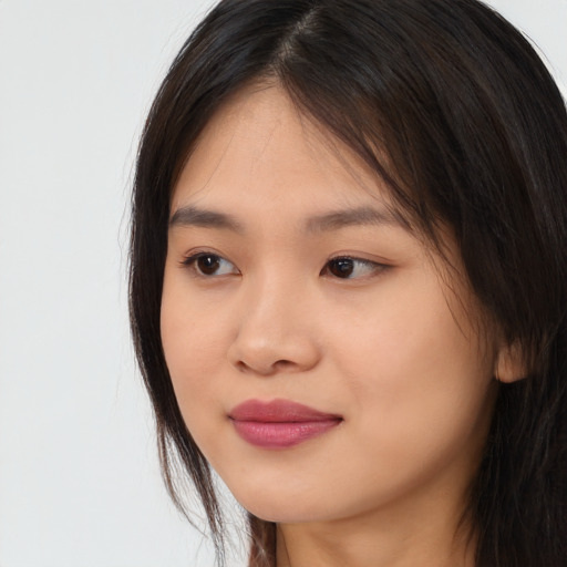 Joyful asian young-adult female with long  brown hair and brown eyes