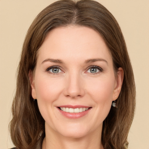 Joyful white young-adult female with long  brown hair and green eyes