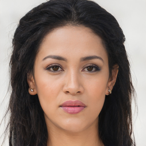Joyful latino young-adult female with long  brown hair and brown eyes