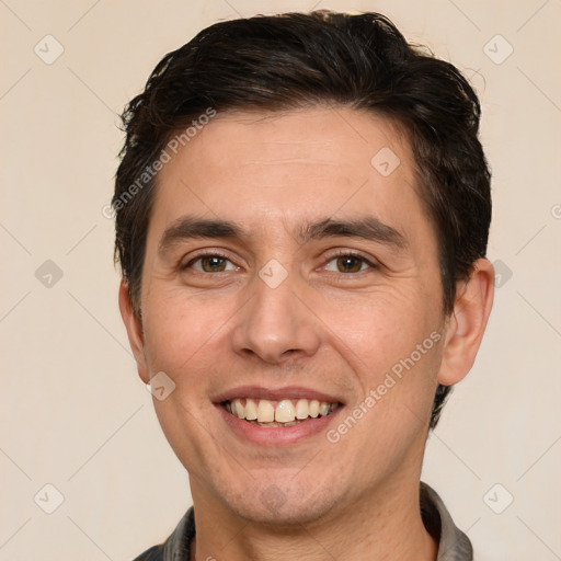 Joyful white adult male with short  brown hair and brown eyes