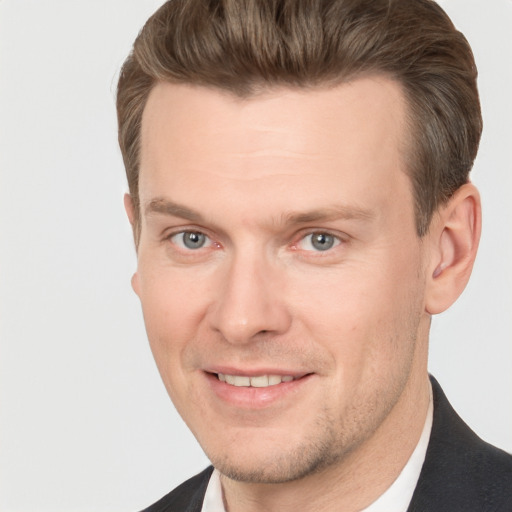 Joyful white adult male with short  brown hair and grey eyes