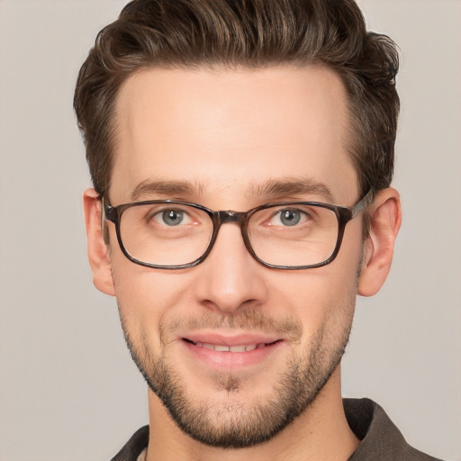 Joyful white young-adult male with short  brown hair and grey eyes