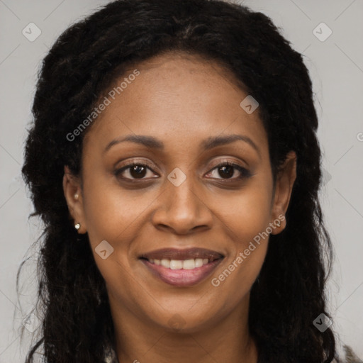 Joyful black adult female with long  brown hair and brown eyes