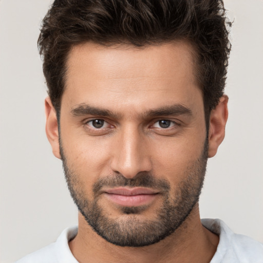 Joyful white young-adult male with short  brown hair and brown eyes