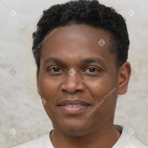 Joyful black young-adult male with short  brown hair and brown eyes