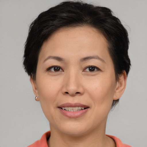 Joyful asian adult female with short  brown hair and brown eyes