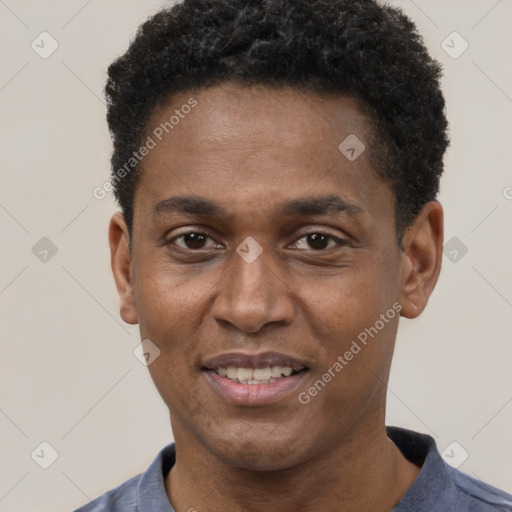 Joyful black young-adult male with short  black hair and brown eyes