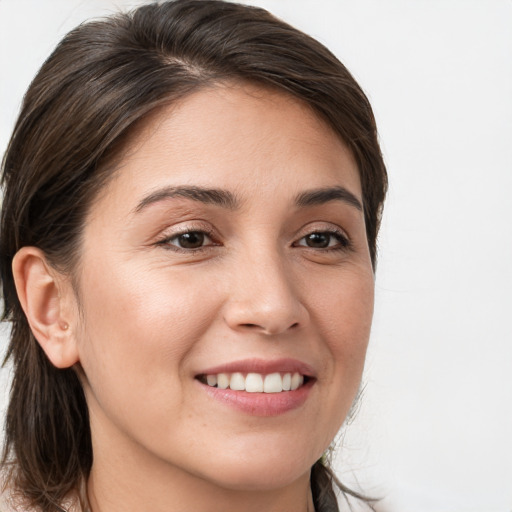 Joyful white young-adult female with medium  brown hair and brown eyes