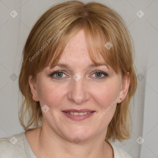 Joyful white adult female with medium  brown hair and blue eyes