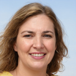 Joyful white adult female with medium  brown hair and brown eyes