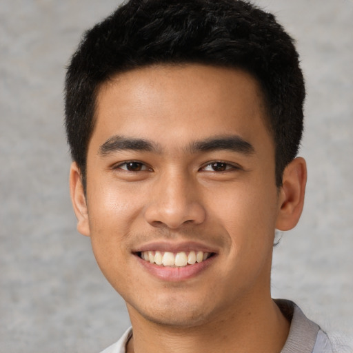 Joyful latino young-adult male with short  black hair and brown eyes