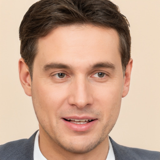 Joyful white young-adult male with short  brown hair and brown eyes