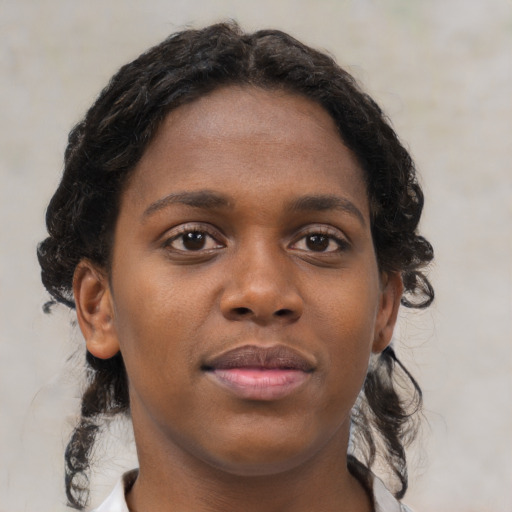 Neutral black young-adult female with medium  brown hair and brown eyes