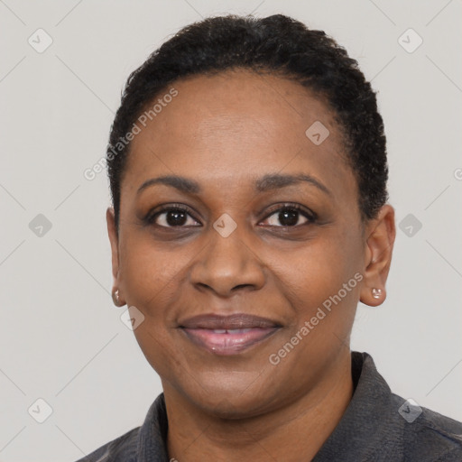 Joyful black adult female with short  black hair and brown eyes