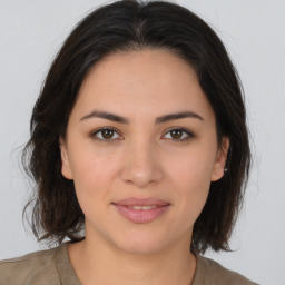 Joyful white young-adult female with medium  brown hair and brown eyes