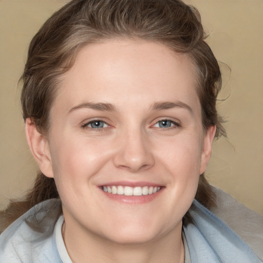 Joyful white young-adult female with medium  brown hair and grey eyes