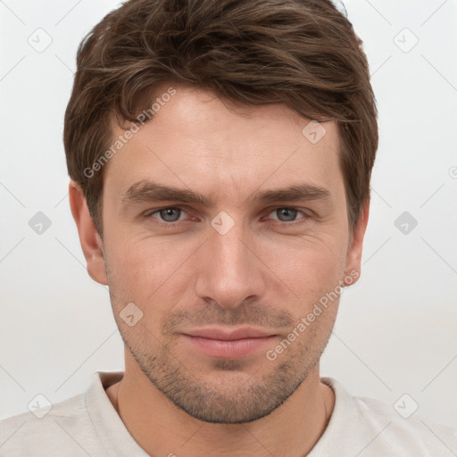 Joyful white young-adult male with short  brown hair and grey eyes