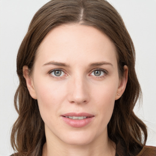 Joyful white young-adult female with long  brown hair and grey eyes