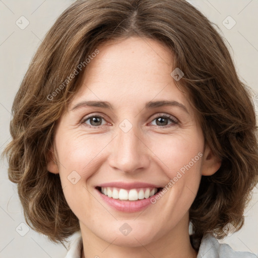 Joyful white young-adult female with medium  brown hair and green eyes