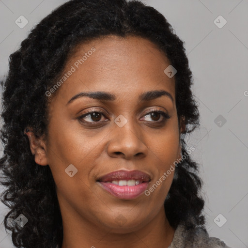 Joyful black young-adult female with long  brown hair and brown eyes