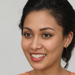 Joyful latino young-adult female with medium  brown hair and brown eyes