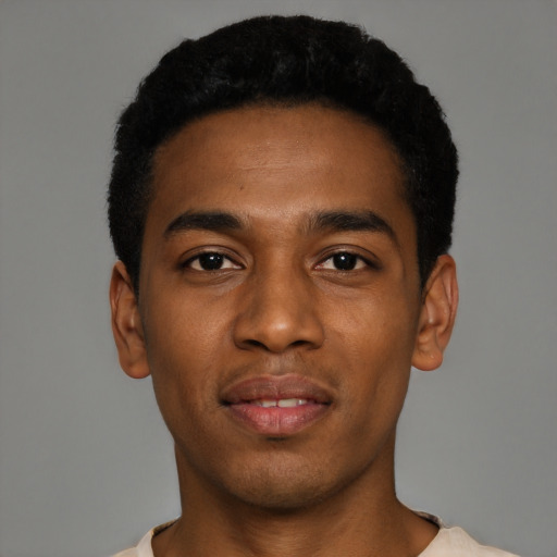 Joyful black young-adult male with short  black hair and brown eyes