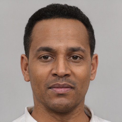 Neutral latino adult male with short  black hair and brown eyes