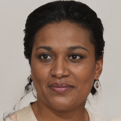 Joyful black adult female with short  brown hair and brown eyes