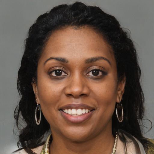 Joyful black young-adult female with medium  brown hair and brown eyes