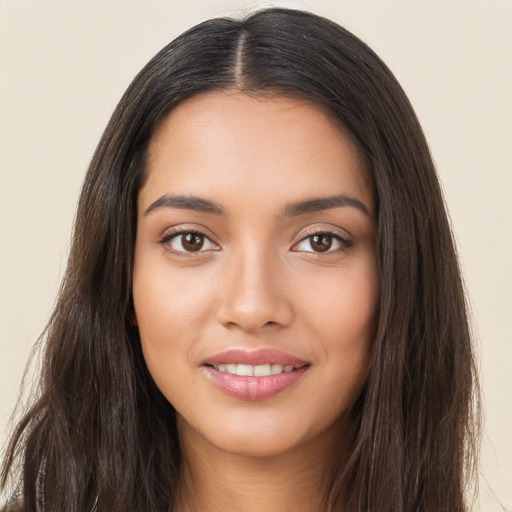 Joyful latino young-adult female with long  brown hair and brown eyes