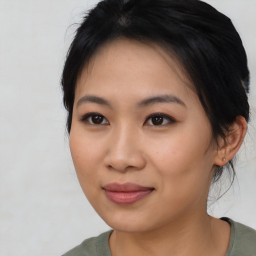 Joyful asian young-adult female with medium  black hair and brown eyes