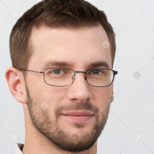 Joyful white young-adult male with short  brown hair and grey eyes