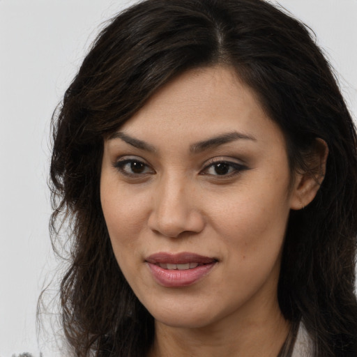 Joyful latino young-adult female with long  brown hair and brown eyes