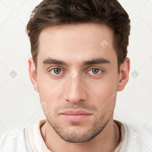 Neutral white young-adult male with short  brown hair and brown eyes