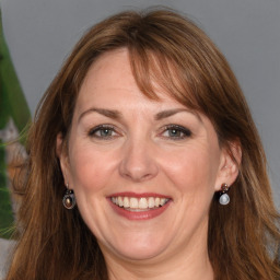 Joyful white adult female with medium  brown hair and grey eyes