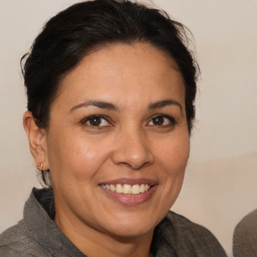 Joyful white adult female with medium  brown hair and brown eyes