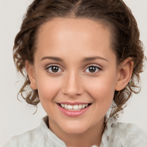 Joyful white child female with medium  brown hair and brown eyes