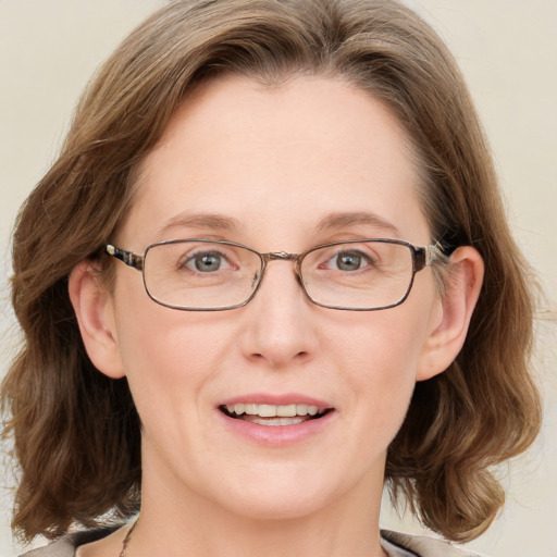 Joyful white adult female with medium  brown hair and blue eyes