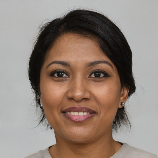 Joyful black young-adult female with medium  brown hair and brown eyes