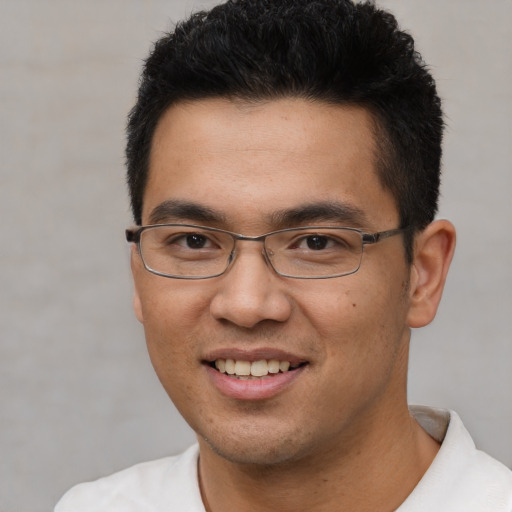 Joyful white young-adult male with short  black hair and brown eyes