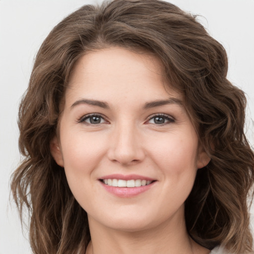 Joyful white young-adult female with long  brown hair and green eyes