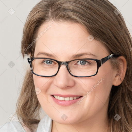 Joyful white adult female with medium  brown hair and blue eyes