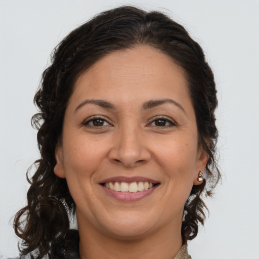 Joyful white adult female with long  brown hair and brown eyes
