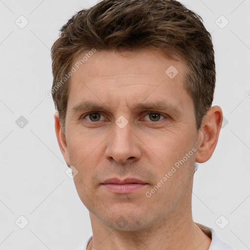 Joyful white adult male with short  brown hair and grey eyes