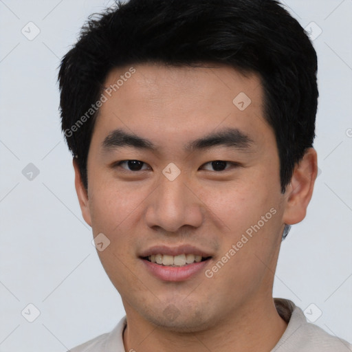 Joyful asian young-adult male with short  black hair and brown eyes