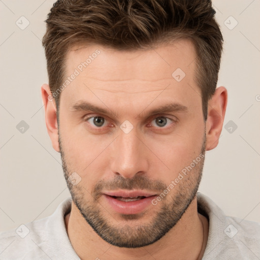 Joyful white young-adult male with short  brown hair and brown eyes