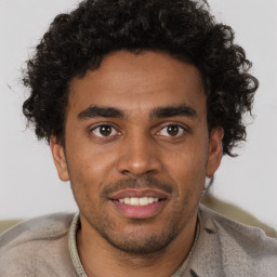 Joyful black young-adult male with short  brown hair and brown eyes